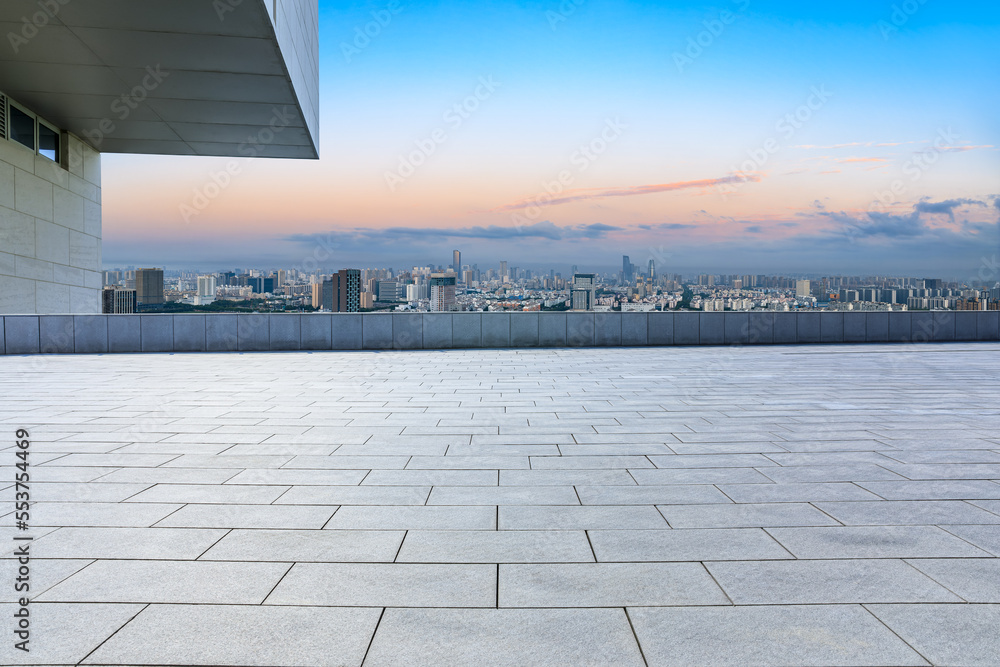 Empty square floor and modern city skyline with buildings at sunset in Ningbo, Zhejiang Province, Ch