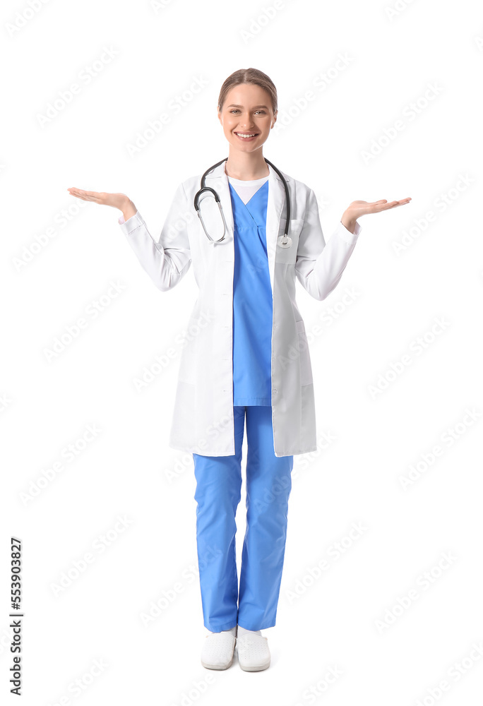 Smiling female doctor showing something on white background