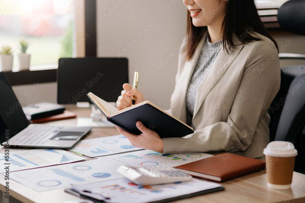 businesswoman hand working with new modern computer and writing on the notepad strategy diagram as c