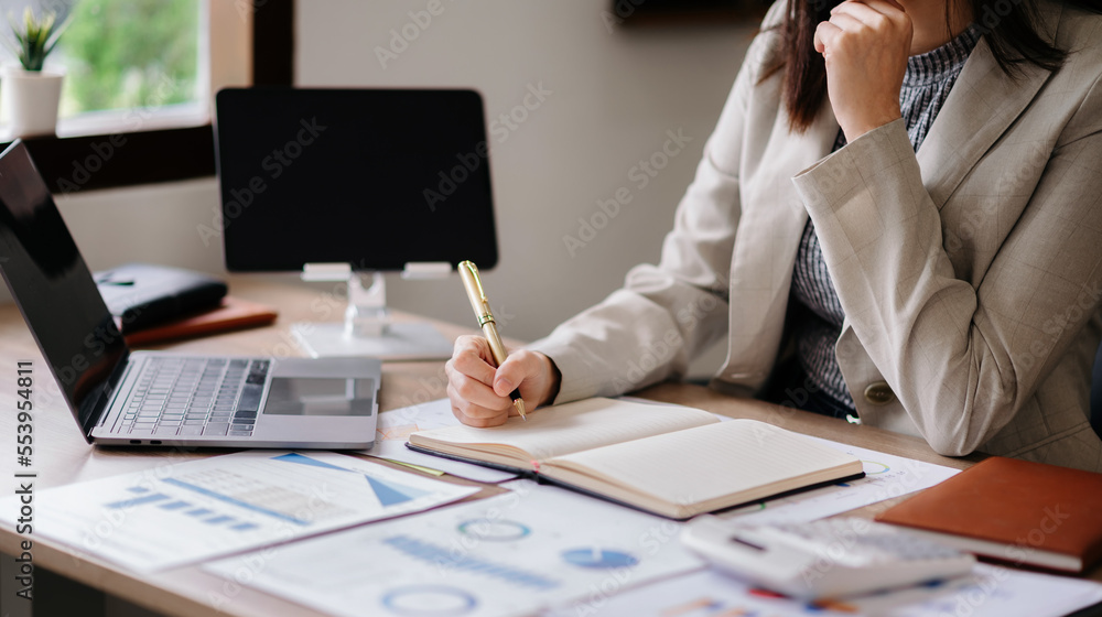 businessman hand working with new modern computer and writing on the notepad strategy diagram as con