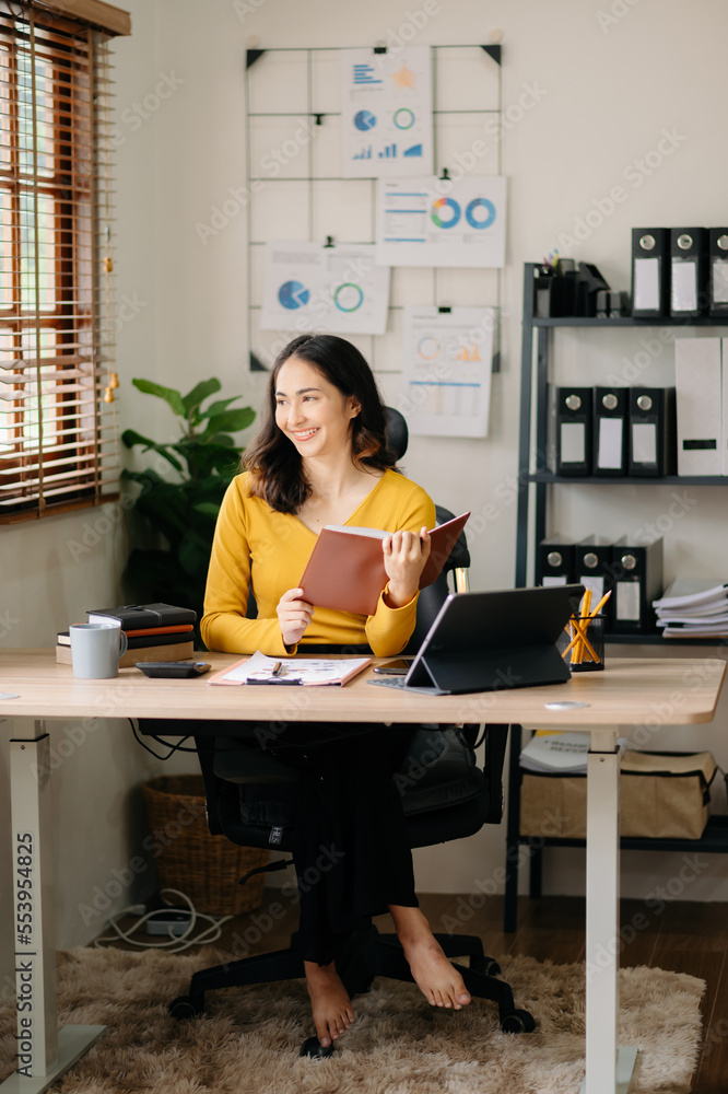 Asian woman reading book while sitting at  in cafe or home