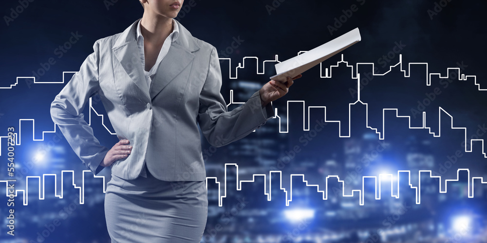 Woman architect or engineer presenting construction concept and holding documents in hand