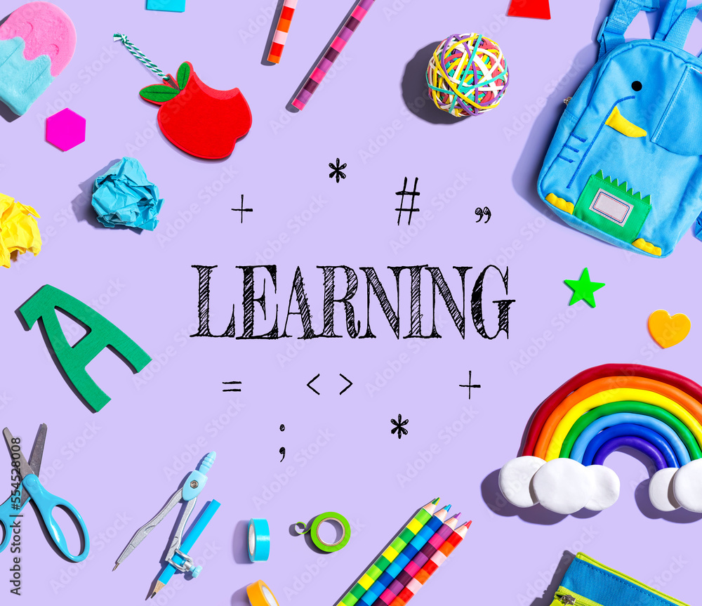 Learning concept with school supplies on a purple background - flat lay