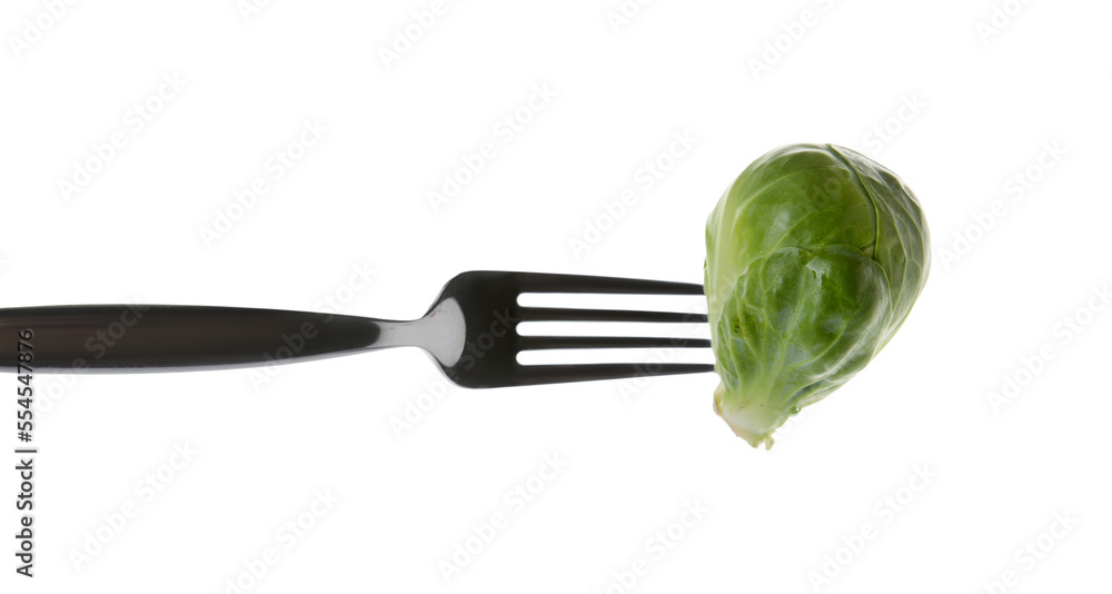 Fork with fresh Brussels cabbage isolated on white background