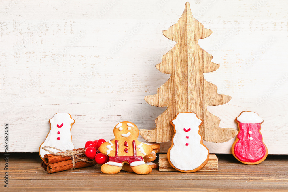 Composition with tasty Christmas cookies and decor on wooden table