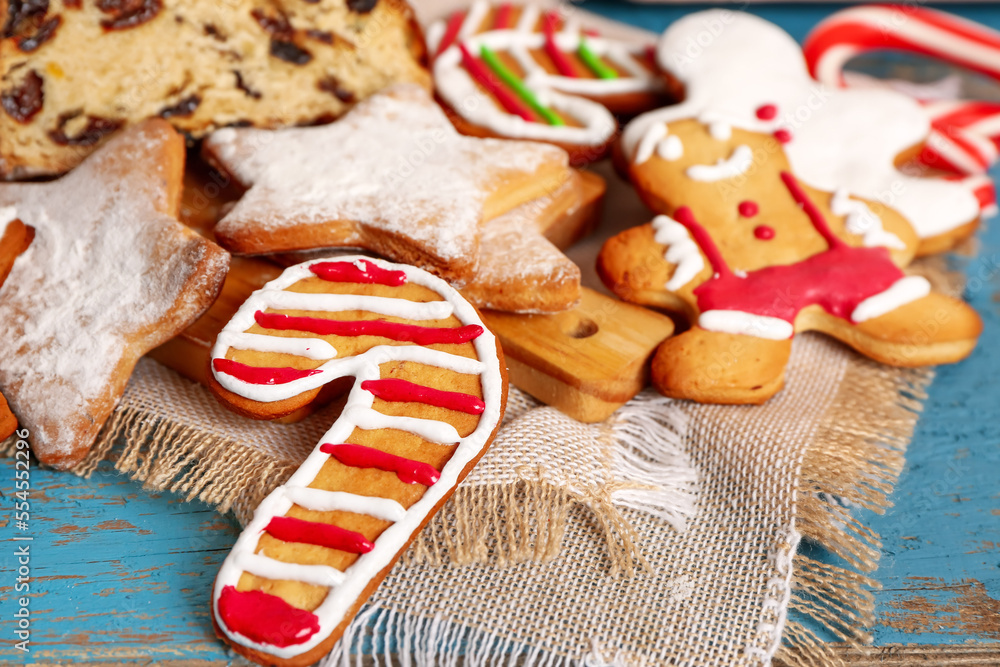 Tasty Christmas cookies on color wooden table, closeup