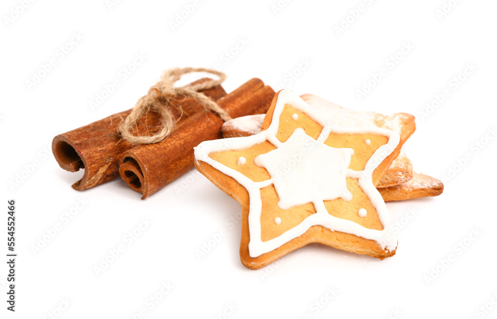 Sweet Christmas cookies and cinnamon sticks on white background