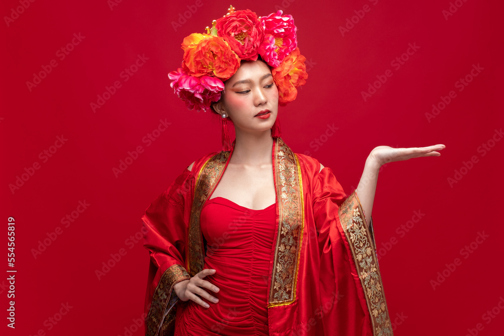 年轻的亚洲女性，穿着时尚的现代qipao-cheonam连衣裙，头上戴着花朵，带有产品预设