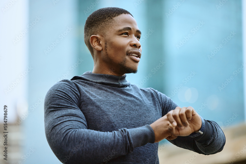 Running, fitness and watch with a sports black man checking his time while outdoor for a cardio run.