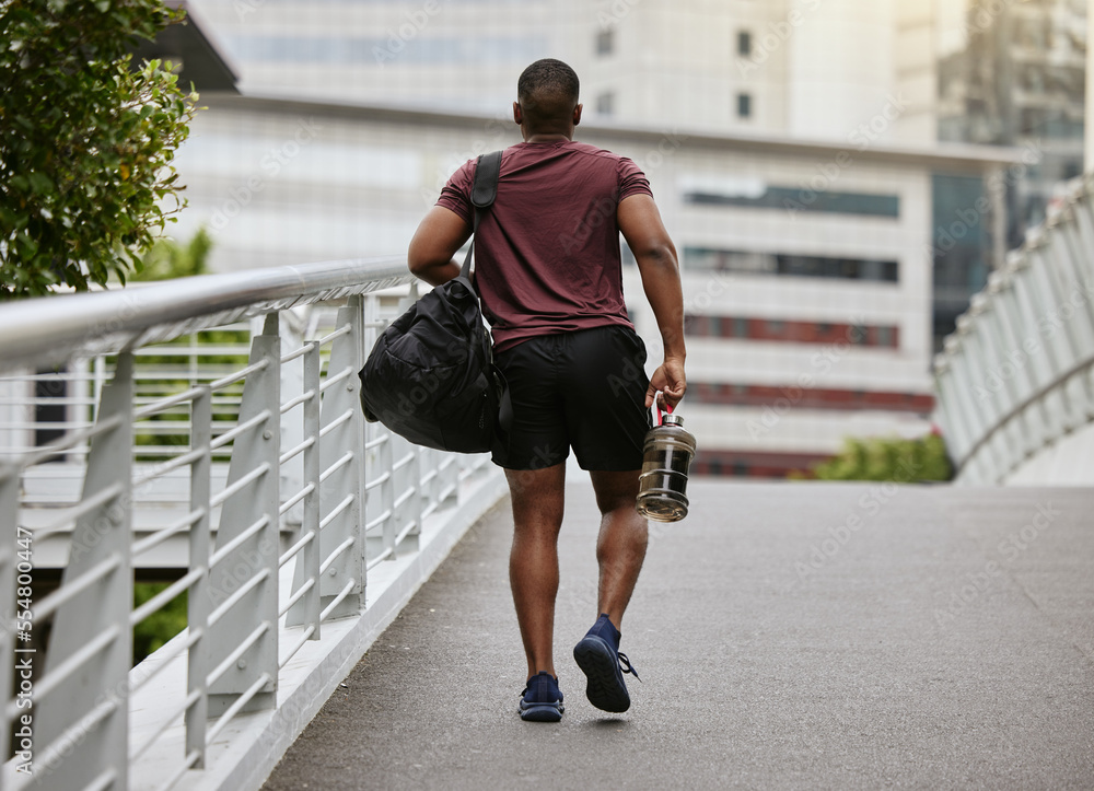 Fitness, health and man walking to gym with bag and water bottle ready for training or exercise work