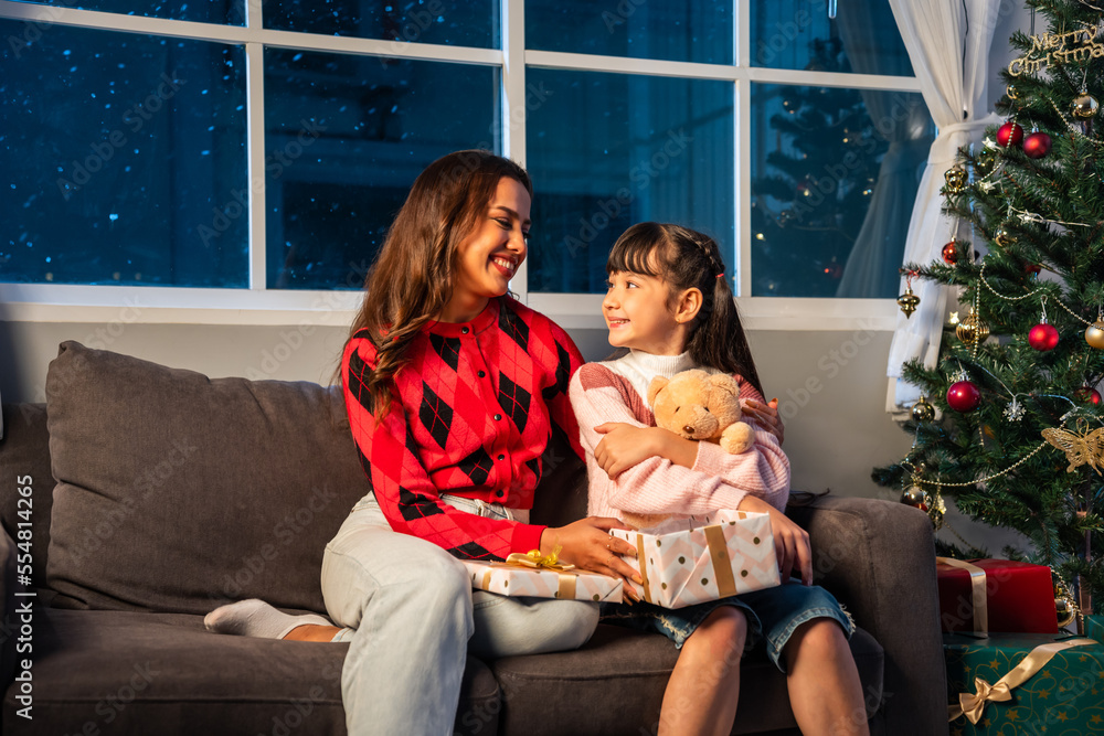 Caucasian family exchanging presents during Christmas party at home. 