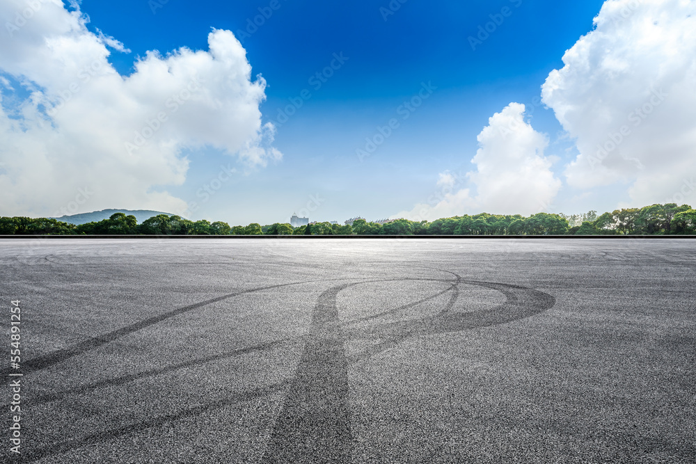 Empty asphalt road and green tree with sky clouds background