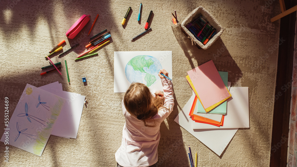 Top View: Little Girl Drawing Our Beautiful Planet Earth. Very Talented Child Having Fun at Home, Im