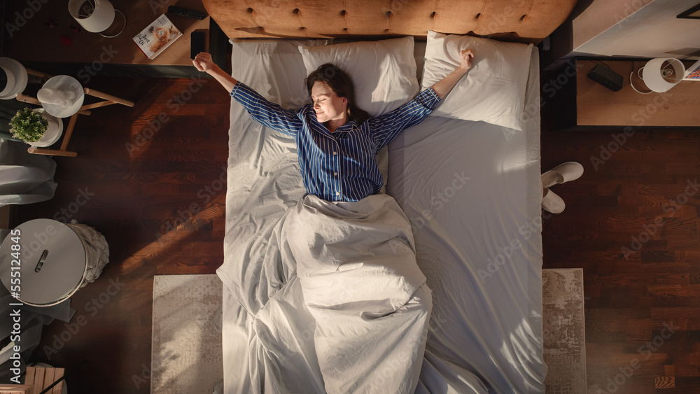 Top View Apartment: Beautiful Young Woman Sleeps Charmingly in Her Bed, Turns off Smartphone Alarm C