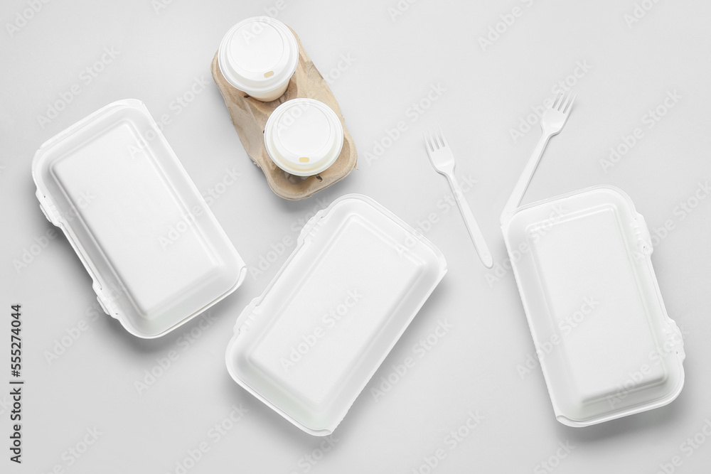 Assortment of food delivery containers on light background