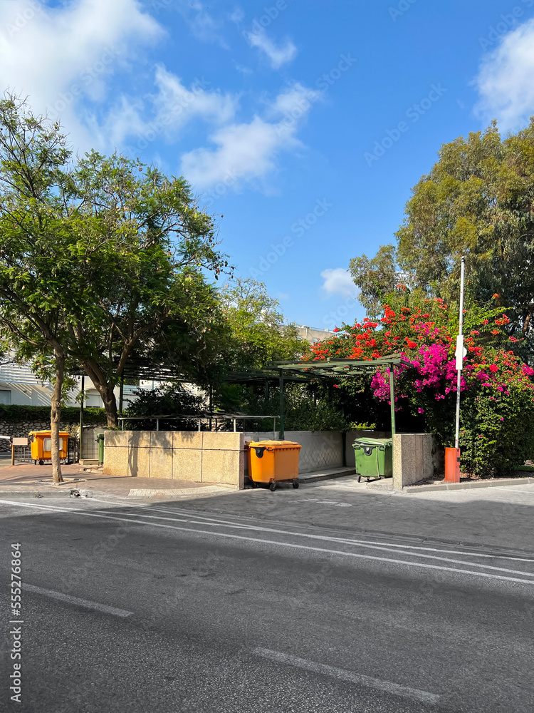 View of city street with modern trash cans