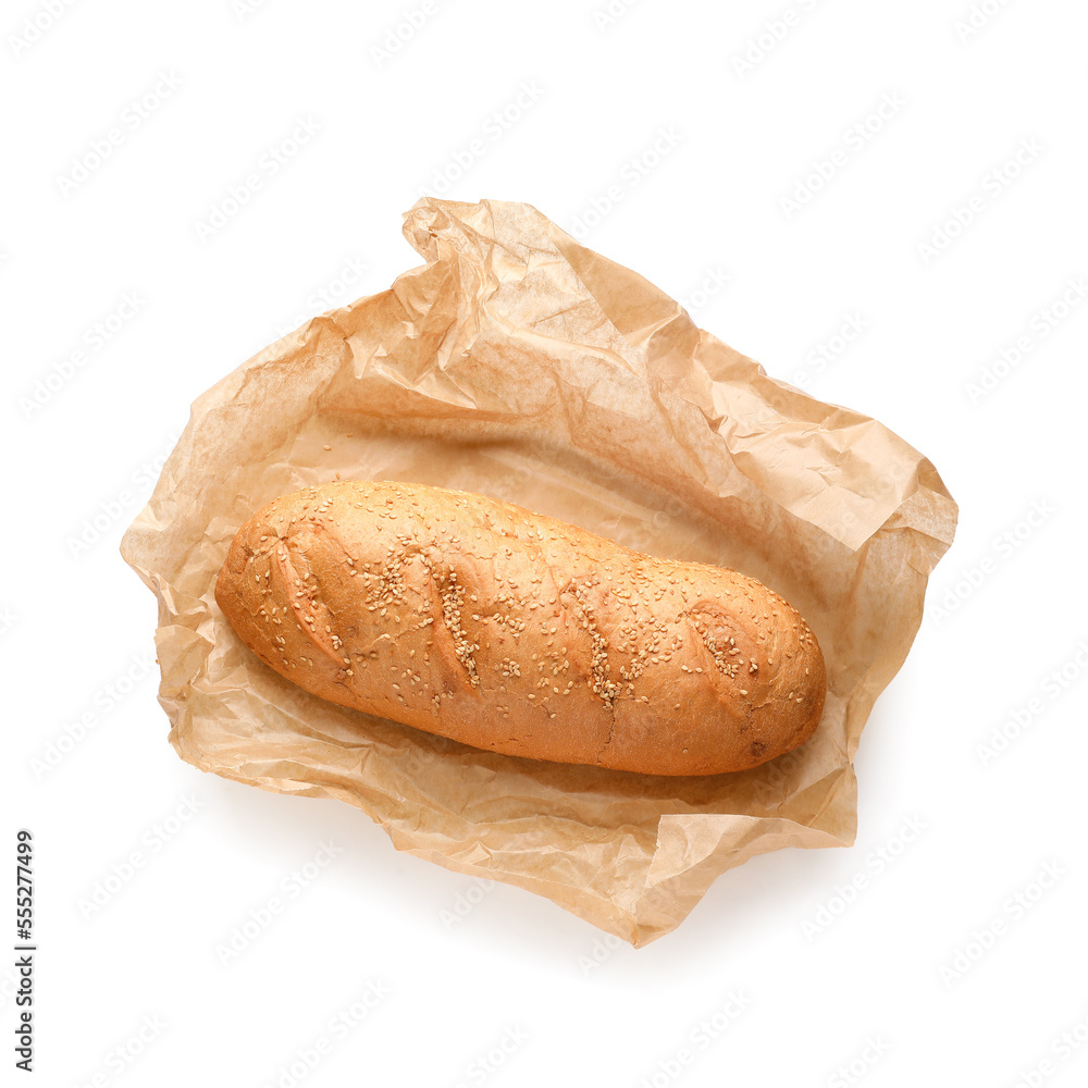 Baking paper with loaf of fresh bread on white background