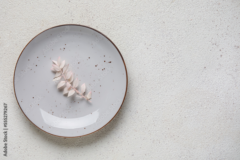 Plate with floral decor on grey background