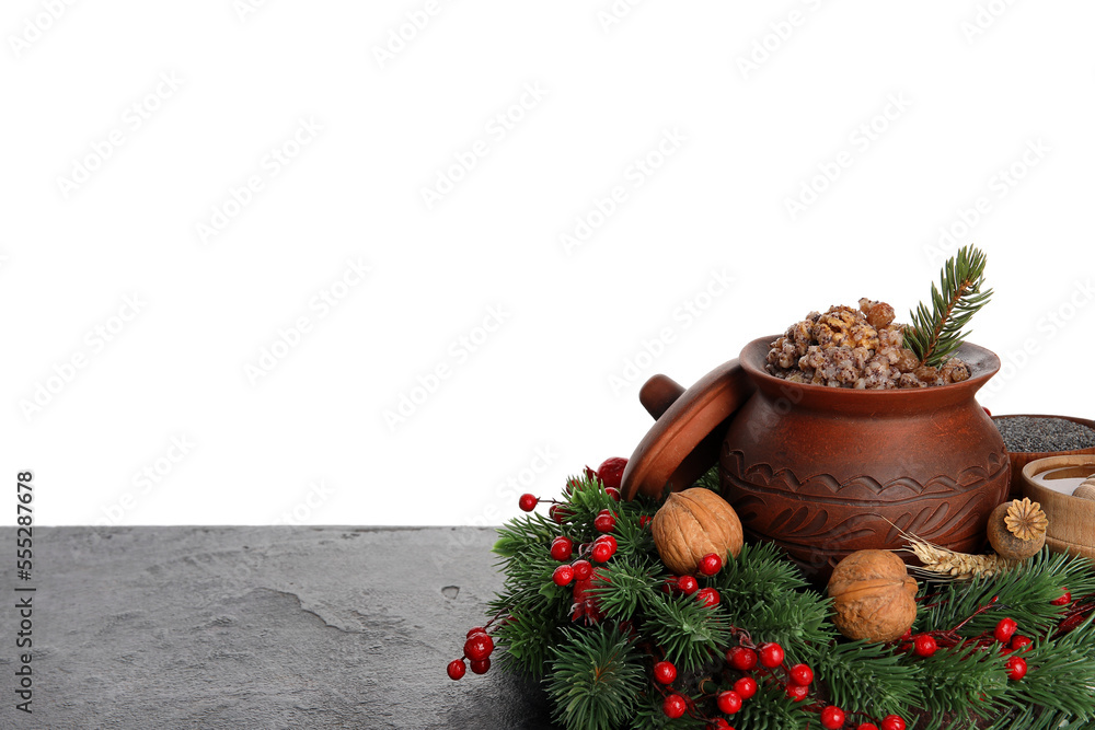 Pot of Kutya with nuts and Christmas wreath on table against white background