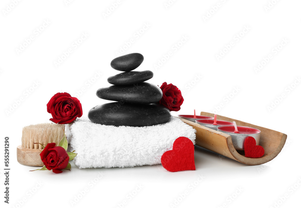 Beautiful spa composition for Valentines Day with flowers, candles, towel and stones on white backg