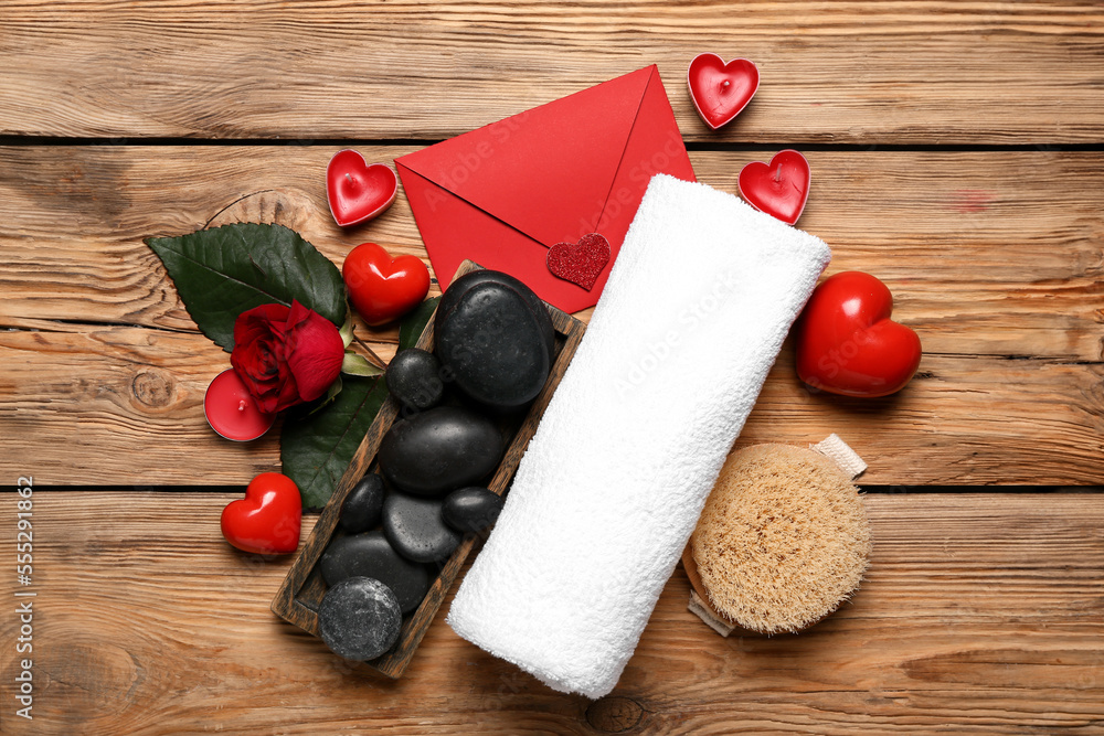 Beautiful spa composition for Valentines Day with envelope, stones, candles, towel, hearts and rose