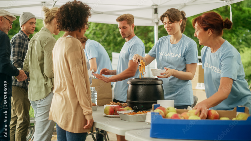 Humanitarian Organization Fighting Hunger: Volunteers Preparing Free Food and Feeding Local Communit