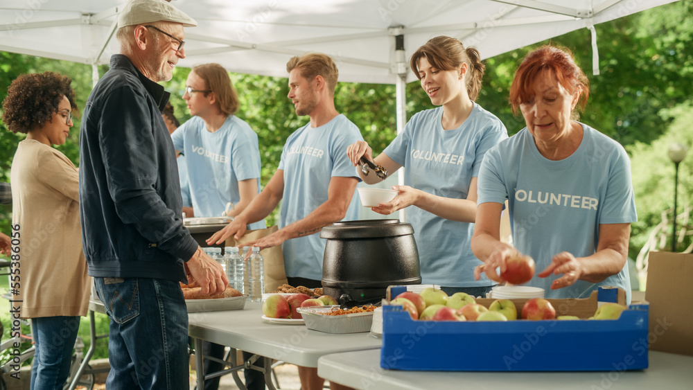 The Concept of Giving: Homeless People Reach Out To Free Volunteer Meals from Multiethnic Team of Vo