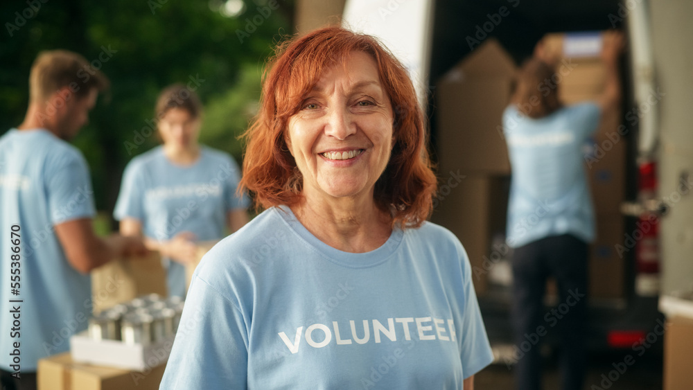 Portrait of a Happy Helpful Middle Aged Female Volunteer. Adult Caucasian Woman in Blue T-Shirt, Smi