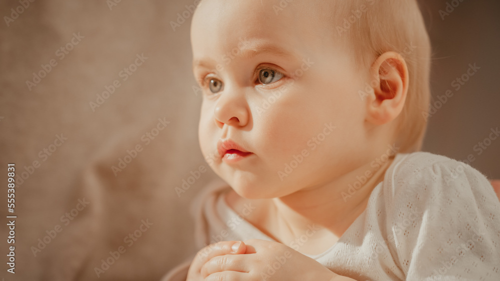 Close Up Portrait of a Little Adorable Child with Light Blond Hair. Happy Infant Girl with Positive 