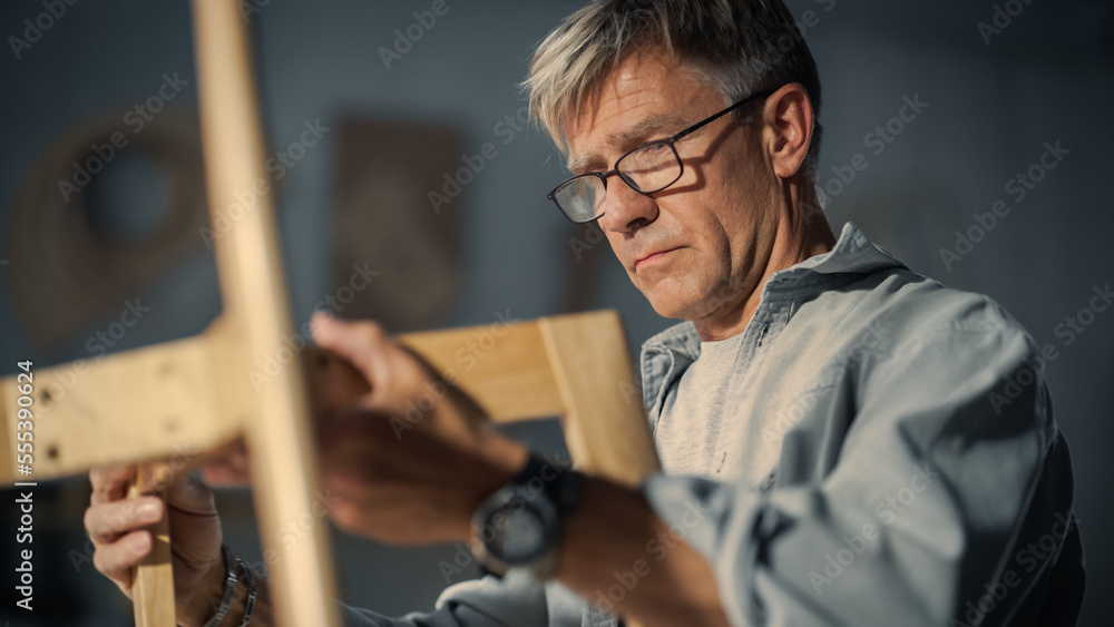 Close Up of a Carpenter Putting on Glasses, Looking at a Blueprint and Starting to Assemble a Wooden