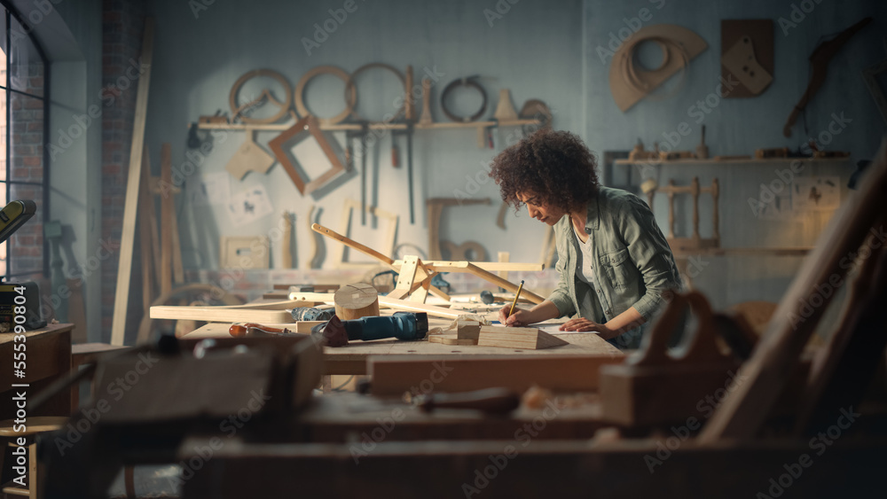 Multiethnic Artisan Woodworker Marking Out Dimensions on a Blueprint and Starting to Assemble a Wood