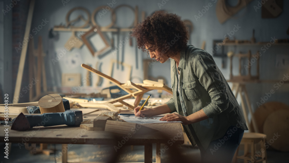 Portrait of a Young Beautiful Carpenter Checking a Blueprint and Starting to Assemble a Wooden Chair