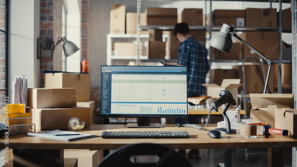 Desktop Computer Monitor Standing on a Table with Statistics and Data Display. Small Business Storag