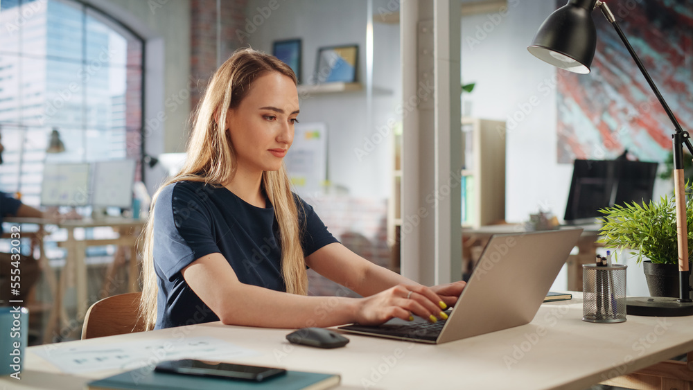 Beautiful Female in a Black Casual Dress Sitting at a Desk in Creative Office, Working on Tasks on L