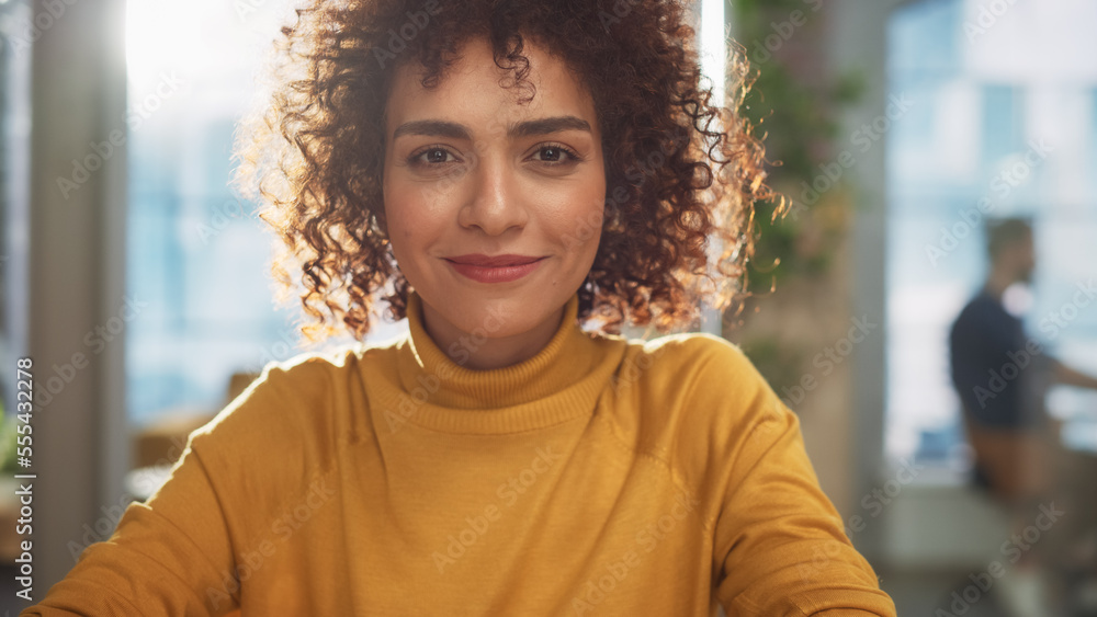 Portrait of a Beautiful Middle Eastern Manager Sitting at a Desk in Creative Office. Young Stylish F