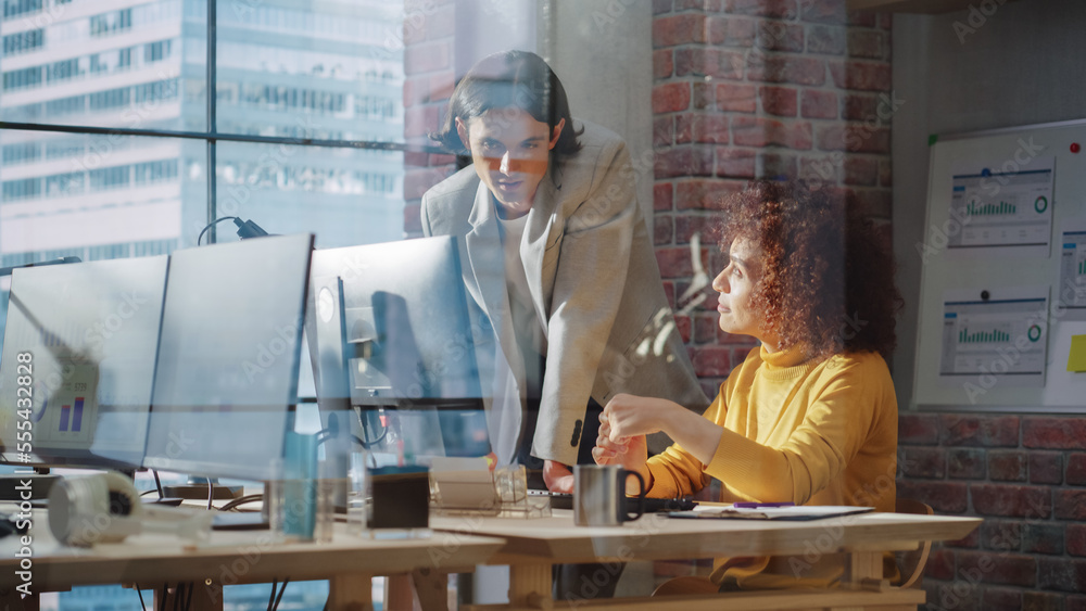 Small Team of Men and Women Working with Analytical Data on Computers in an Agency with Big Window w