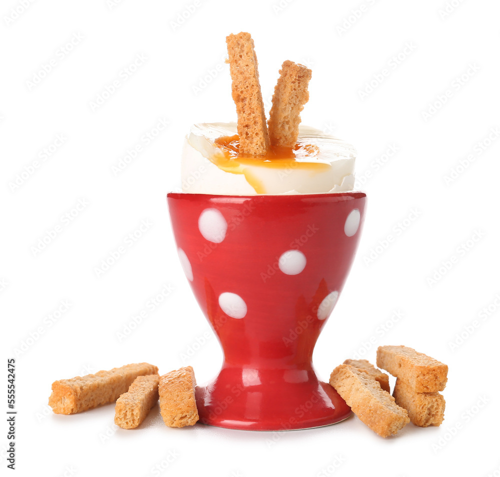 Cup with soft boiled egg and croutons on white background