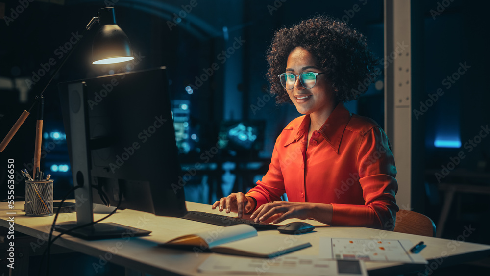 Beautiful Multiethnic Brazilian Female Working on Desktop Computer Late at Night. Young Creative Man