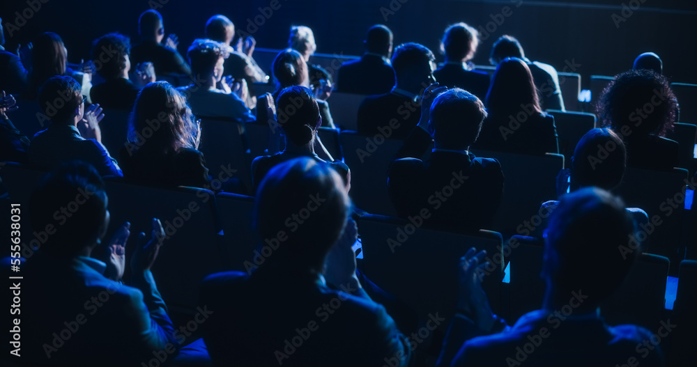 Crowd of Smart Tech People Applauding in Dark Conference Hall During a Motivational Keynote Presenta