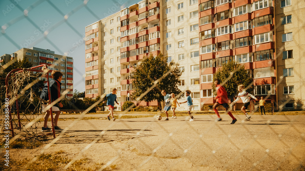 Sporty Multiethnic Diverse Kids Playing Soccer in Their Backyard on a Sunny Day in Summer. Cheerful 