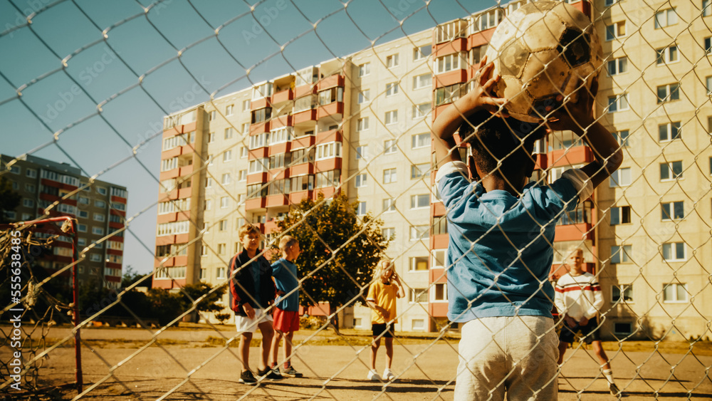 Young African Boy Throwing the Ball from Offline, Neighborhood Kids Starting to Play Soccer in the H