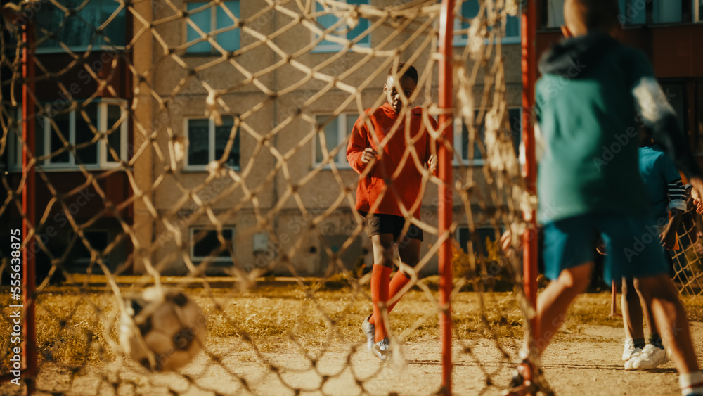 Multiethnic Diverse Friends Playing Soccer Outside in Urban Backyard. Young African American Boy Dri