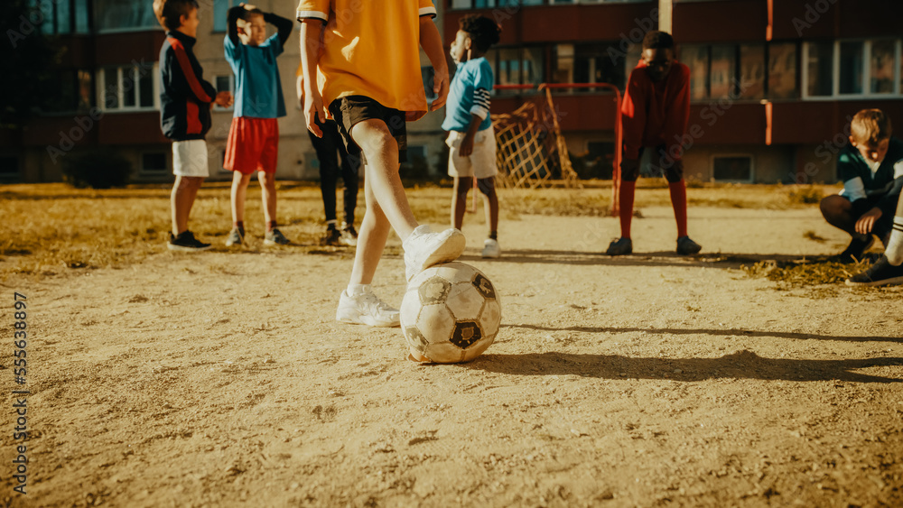 Cute Girl Playing Keepie Uppies with a Soccer Ball Together with Multiethnic Kids in the Neighborhoo