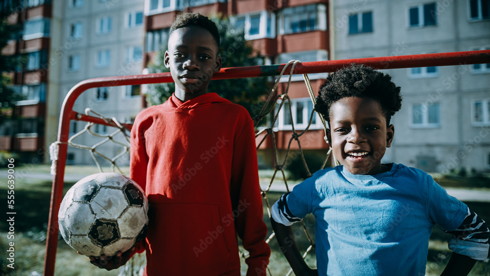 Portrait of Two Young Talented African Boys Standing Together while Looking at Camera and Smiling. O