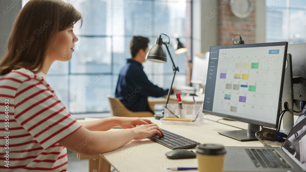 Portrait of a Young Creative Woman Working on a Computer in Modern Office. Caucasian Female Chief Ma