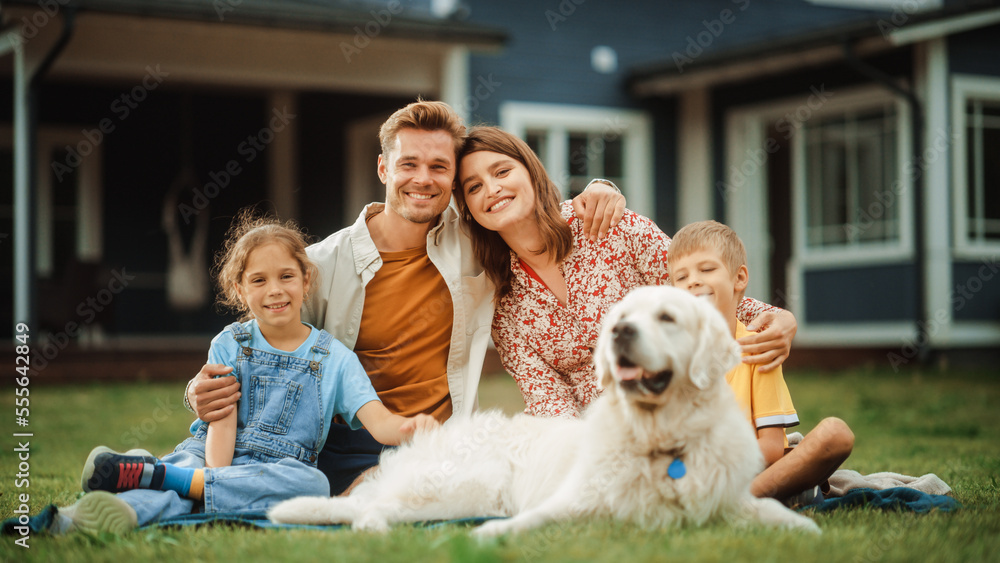 Portrait of a Cheerful Family Couple with a Son and Daughter, and a Beautiful Golden Retriever Dog S