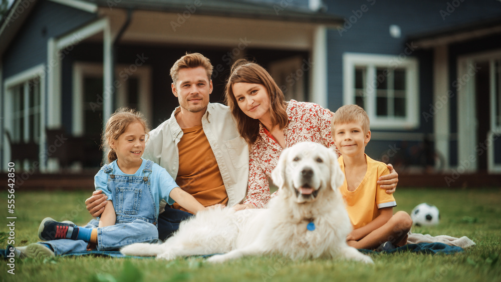 Portrait of a Happy Young Family Couple with a Son and Daughter, and a Noble White Golden Retriever 