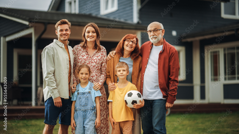 Portrait of a Happy Family Couple with a Son and Daughter as well as Grandparents, and a White Golde