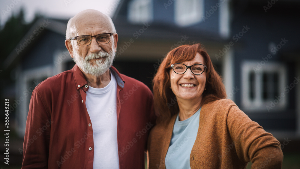 Happy Senior Couple Posing Outdoors Their Residential Area Home, Embracing Each Other. Loving Adults