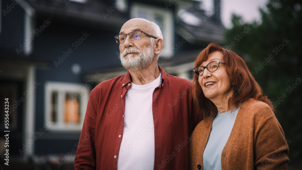 Happy Senior Couple Posing Outdoors Their Residential Area Home, Embracing Each Other. Loving Adults